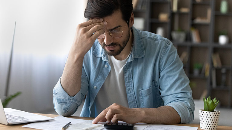 Man placing hand on forehead in frustration